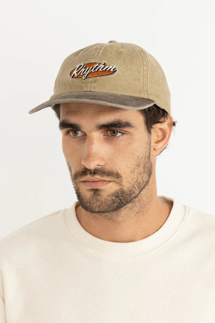 Stay relaxed and stylish with the Hallmark Cap in Sand. This low-profile, 6-panel cap features a deconstructed design with an embroidered logo that adds subtle sophistication. The adjustable snap back closure ensures a perfect fit, while the pigment wash gives it a vintage appeal, enhanced by Rhythm labels and trims