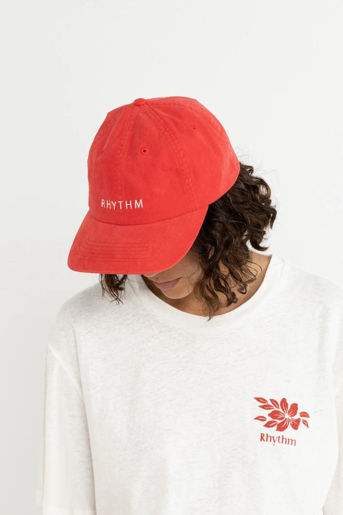 Embrace bold style with the Rhythm Essential Cap in Cherry. This cotton canvas cap features front embroidery artwork and an adjustable metal slider at the back, providing both comfort and a touch of vibrancy to your outfit.