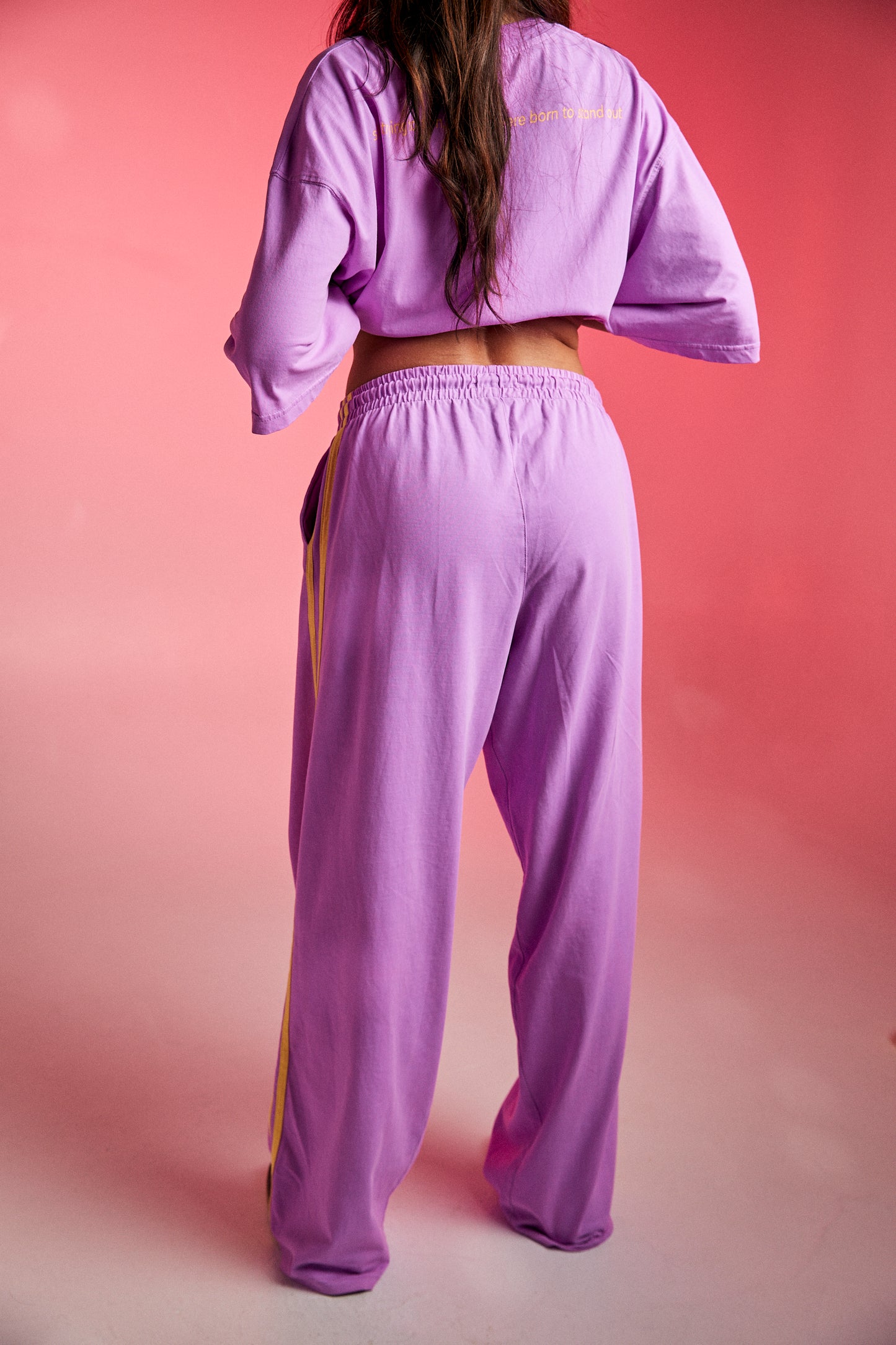 Bright, bold, and unapologetically fun — meet The Chido Pants - Fluro Purple, your new go-to for laid-back luxe with a pop of attitude. Crafted from soft, breathable cotton, these relaxed-fit track pants bring comfort and colour in equal measure.