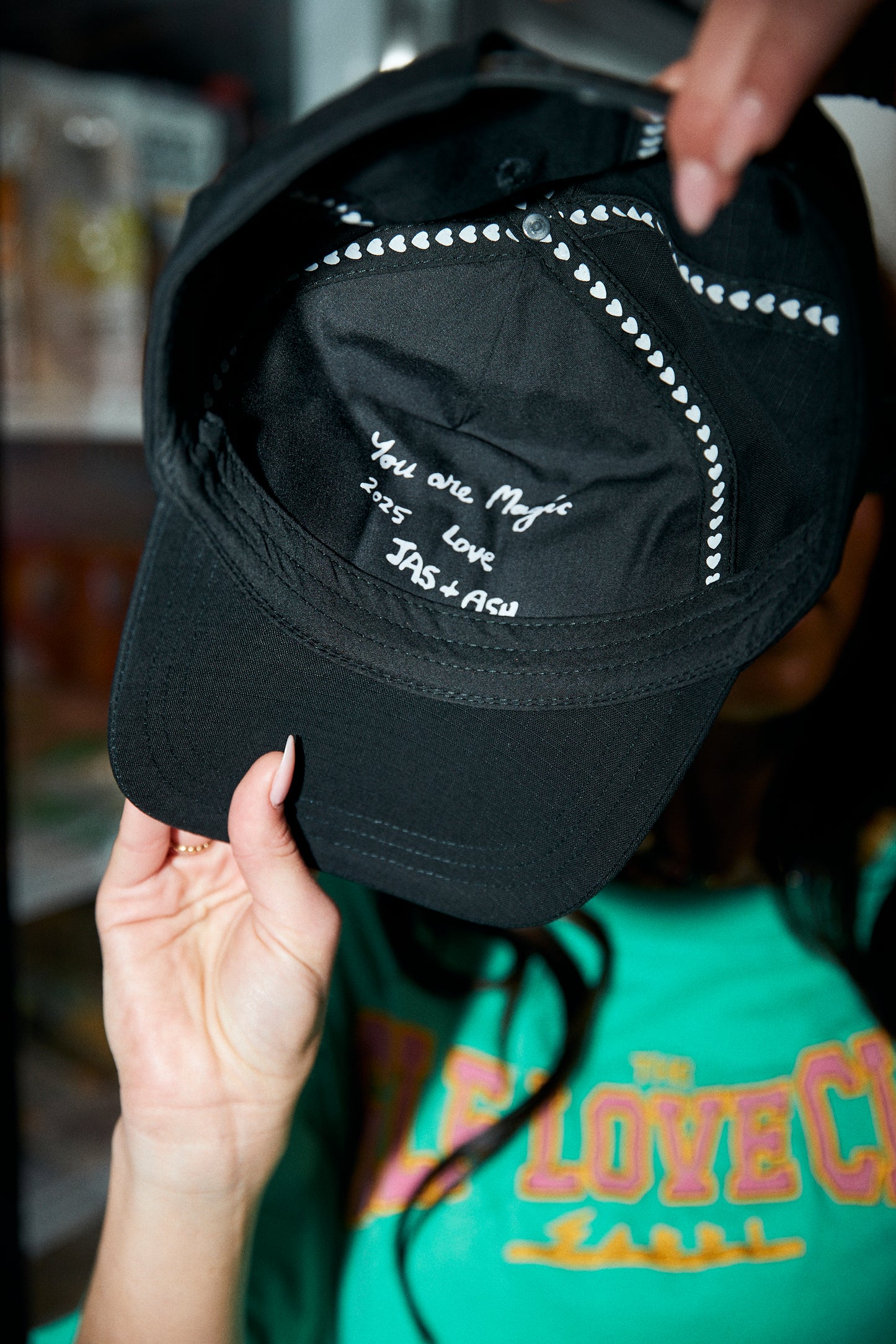 Top off your look with the ultimate dose of self-love energy. The Self Love Club Cap in Black is your go-to accessory for effortless cool and unapologetic confidence. Featuring bold embroidered “SELF LOVE CLUB” lettering in pink and white across the front, this classic curved-brim design is equal parts street style and statement piece.a
Crafted for comfort and everyday wear, it’s fully adjustable at the back for the perfect fit and includes a secret love note embroidered on the inside – “You are Magic – Lo