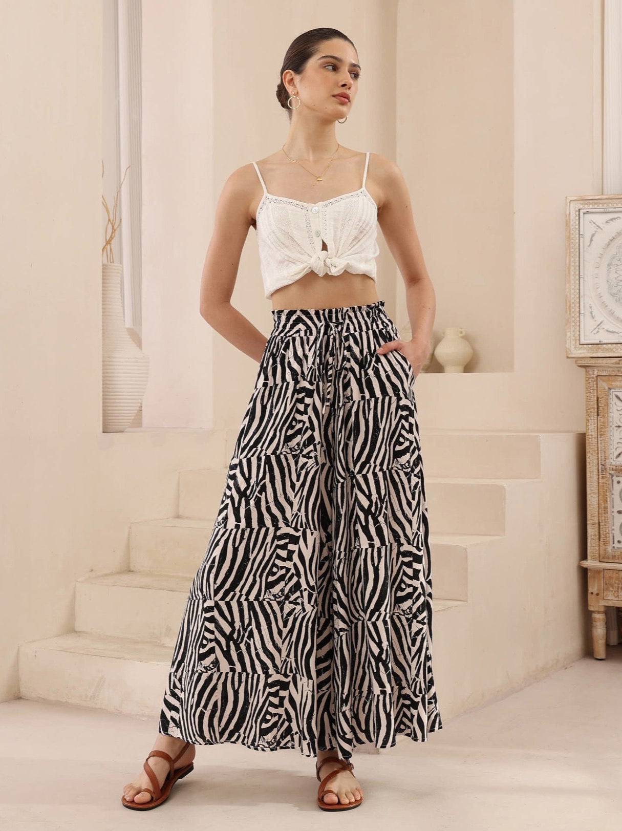 Add a dose of dynamic flair to your wardrobe with the HUNTER Pants, designed in an eye-catching patchwork-style zebra print. These high-waisted, wide-leg pants combine statement fashion with breezy comfort—ideal for sunny days, tropical getaways, or elevated everyday looks.
