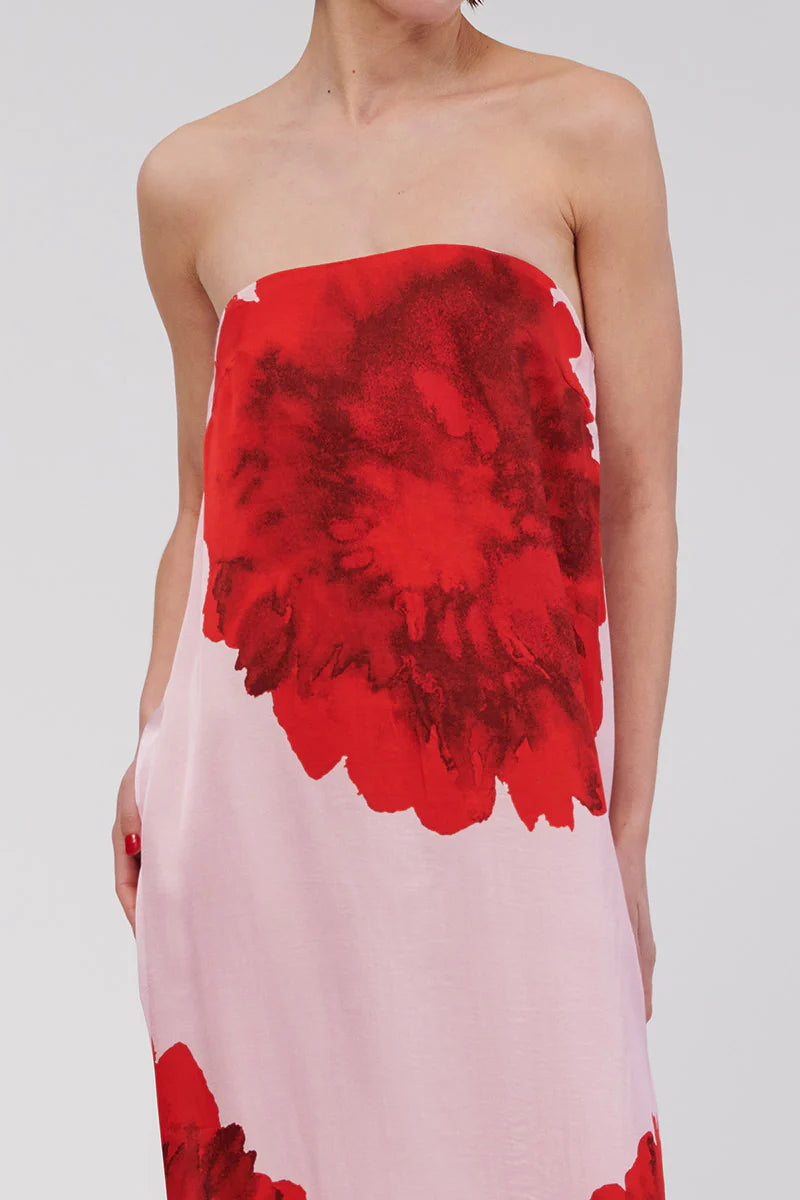Step into relaxed sophistication with the Emilia Bustier Maxi Dress. Featuring a bold, enlarged red floral print on pink, this silky piece is perfect for a daytime event or a balmy summer soirée. Make a statement in this stunning max.v