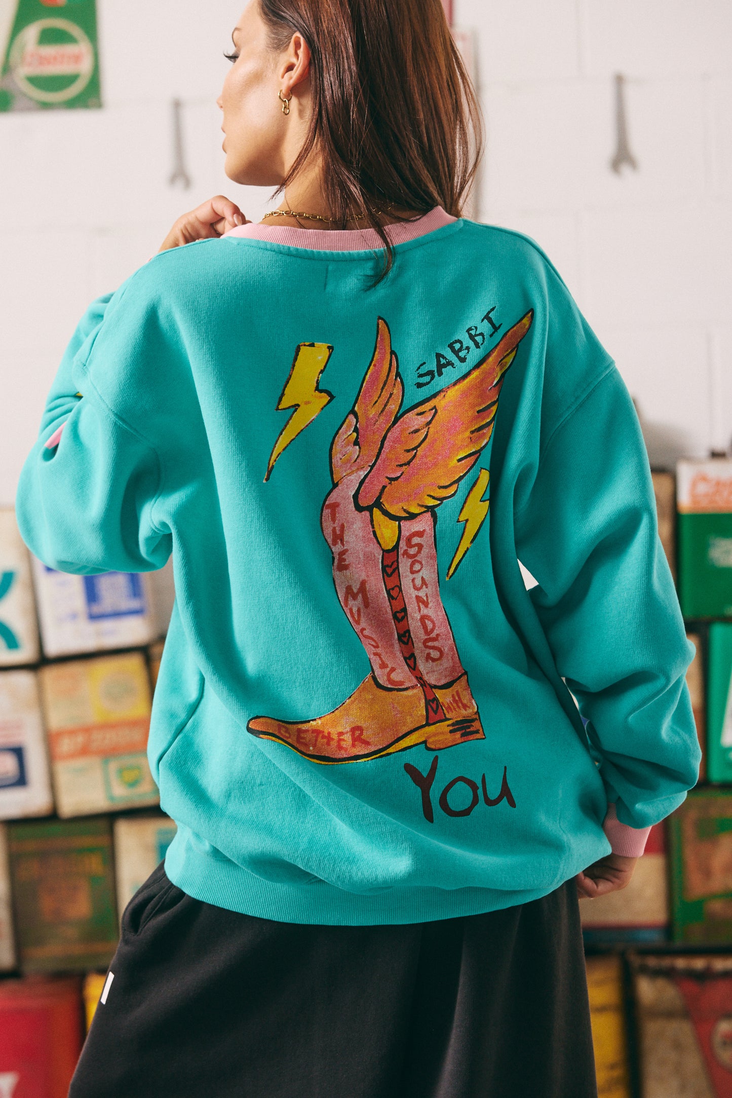 The Born Original Tee – Teal & Pink
Fuel your fire and wear your power proudly in the Born Original Tee – Teal & Pink. This oversized, vintage-sport inspired tee features statement gothic lettering, contrast pink varsity stripes, and bold yellow lightning bolts for an electrifying twist. The teal cotton base brings a fresh pop of colour, while the custom artwork on the back — winged boots and affirmations — reminds you that the world is better with your original energy. Equal parts comfy and cool, t