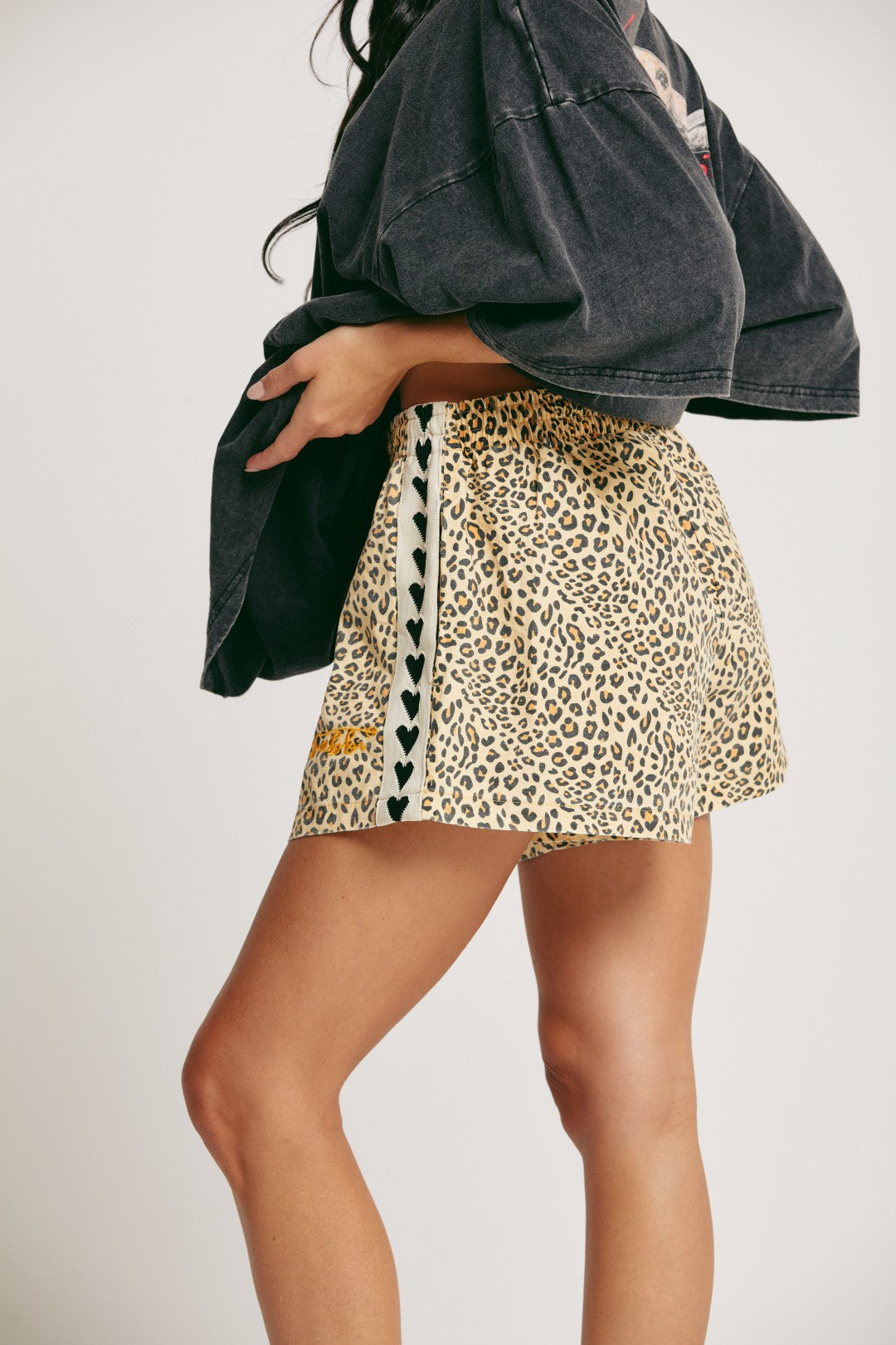 Unleash your wild side with The Mini Hearts Drill Shorts - Leopard, a bold mix of fierce and playful. Designed for all-day comfort with a street-chic edge, these shorts feature a striking leopard print that roars with attitude — balanced by signature contrast heart detailing down the sides for a touch of love-infused flair.