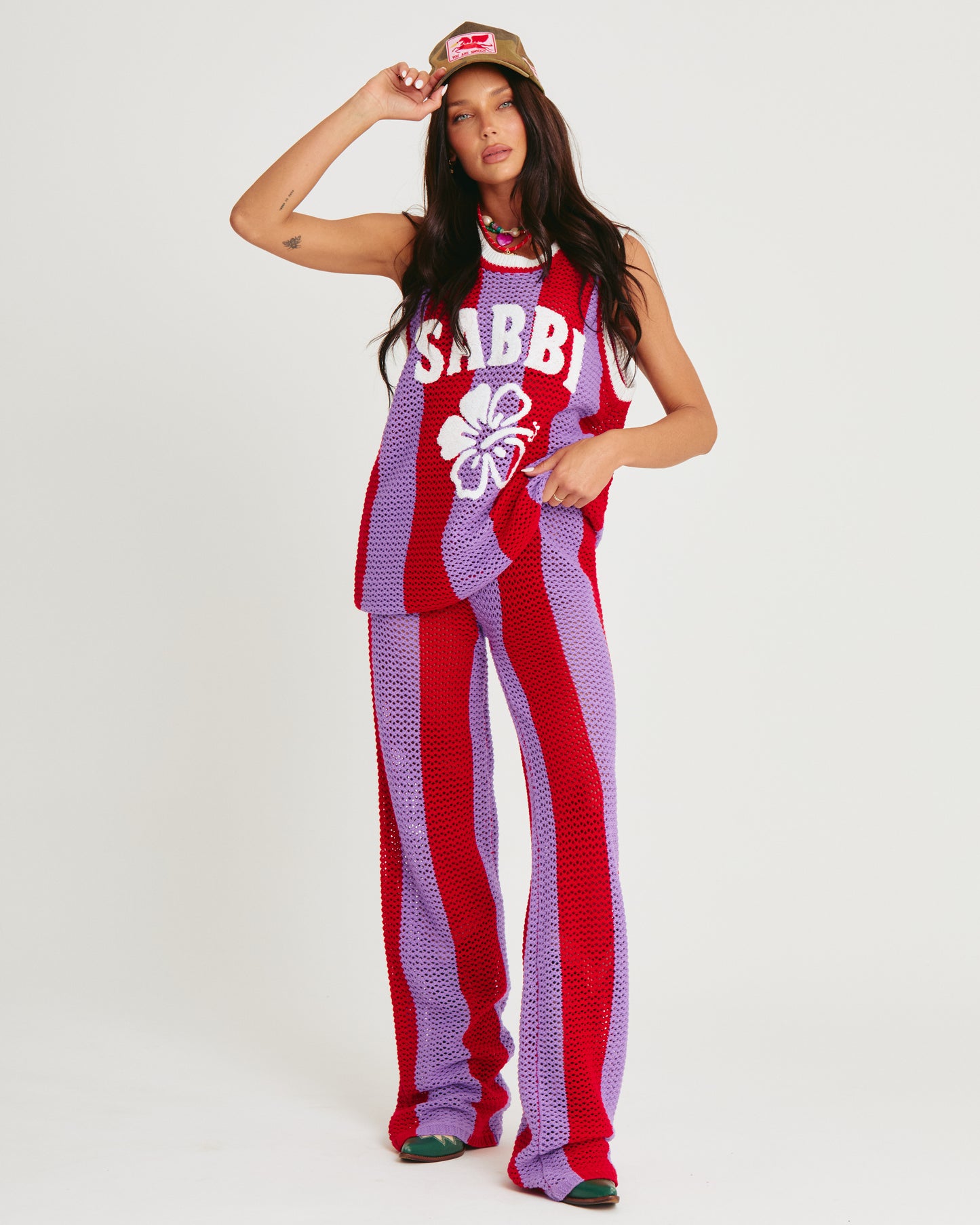 THE KNIT B-BALL SINGLET — PURPLE STRIPE -SABBI
Bring the heat and serve all the courtside attitude in THE KNIT B-BALL SINGLET – PURPLE STRIPE. A bold, retro-sport moment meets handcrafted energy, this statement knit is here to steal the spotlight (and hearts).
Designed in eye-popping purple and fire red stripes, this breathable open-weave crochet singlet is your new go-to for festival days, coastal hangs, or any moment you feel like being unmissable. Featuring an oversized fit, contrast rib trims, and our