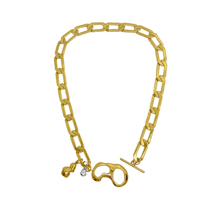 The EVERLEIGH Necklace in Gold commands attention... She exudes strength, sophistication with a hint of 'effortless cool girl' what more could we ask for!? Boasting a beautifully unique t-clasp designed around a fluid motif, adorned with droplets of mix metals, nestled between a chunky angular link chain, evoking the balance between hard and soft. Effortlessly layered or a standout all on her own. The Everleigh Necklace is that unique piece you've been searching for!