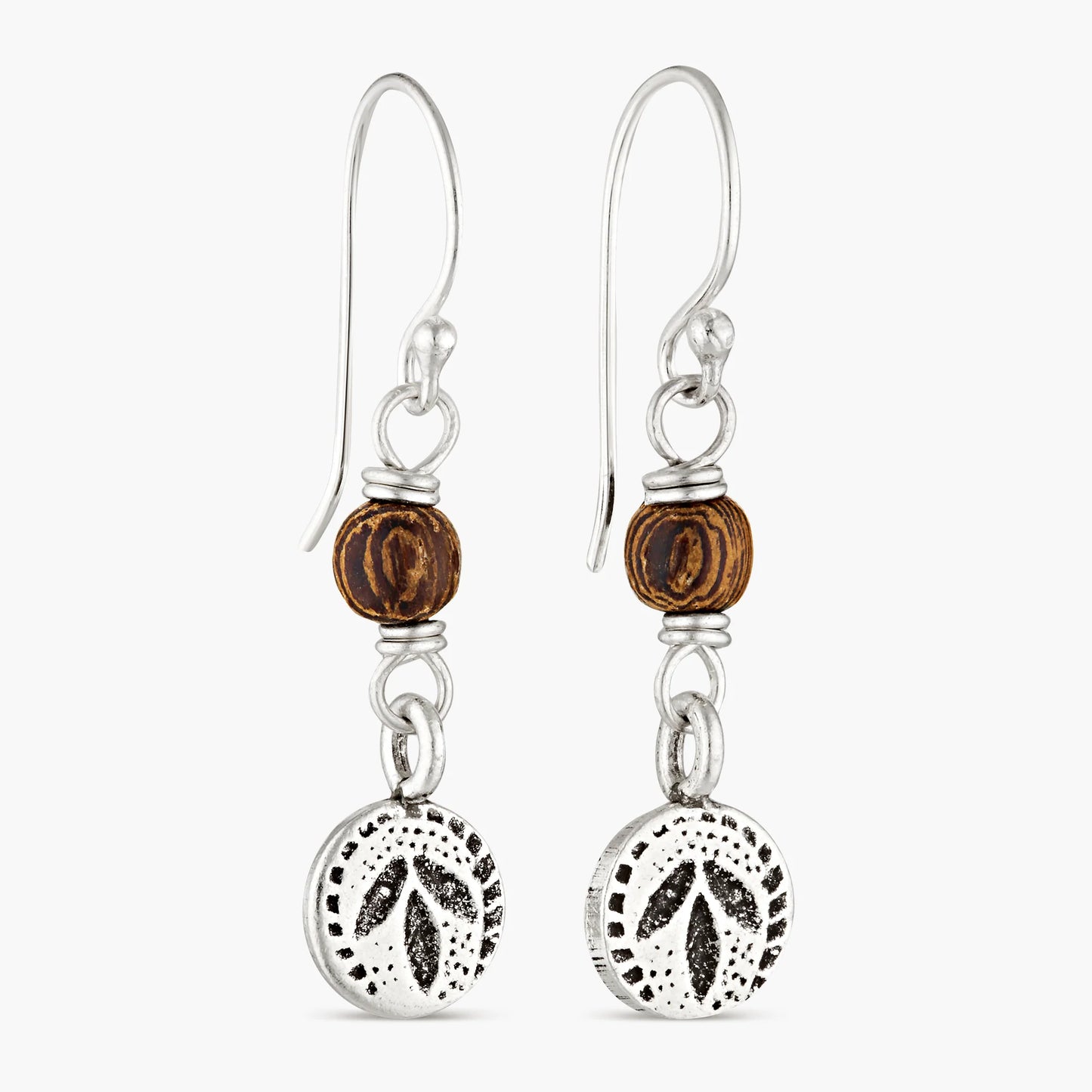 Experience the allure of the tropics with our Tropical Leaf Drops. These exquisite earrings are a harmonious blend of nature's finest elements. Crafted with precision, they feature a handcrafted and hand-stamped hilltribe silver leaf charm, symbolising growth and vitality. The tumbled wooden bead adds an earthy touch, reminiscent of the forest's tranquility.