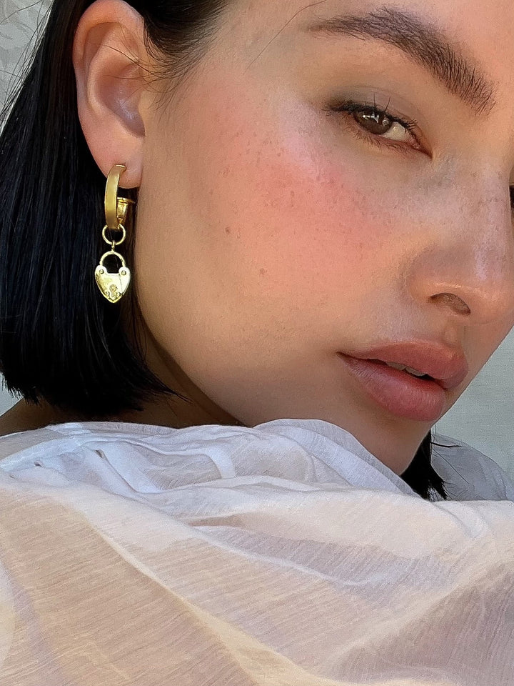 Our bestselling Heart Mini Hoops are a little earring moment that our MM Women absolutely adore! We all love a baby hoop and these goldies are no exception. They easily dress up any outfit, especially with the addition of our gorgeous charms, or they are perfect on their own if you choose to slide the charms off. To be honest, we have been known to wear these for most occasions, including walking the dog and going to pilates. They really are your everyday earring bestie!
