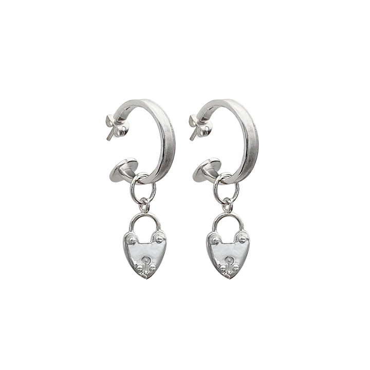 Our beloved Heart Mini Hoops, now in silver, are a perfect addition to any outfit. Whether worn with our gorgeous heart locket charms or solo, yes the charms are removable! These mini silver hoops are such a cute & eye-catching accessory. Maybe you're running errands, attending a special event, or exercising, these small but mighty earrings are a perfect complement to your look. They're your go-to everyday earring that are never boring. 