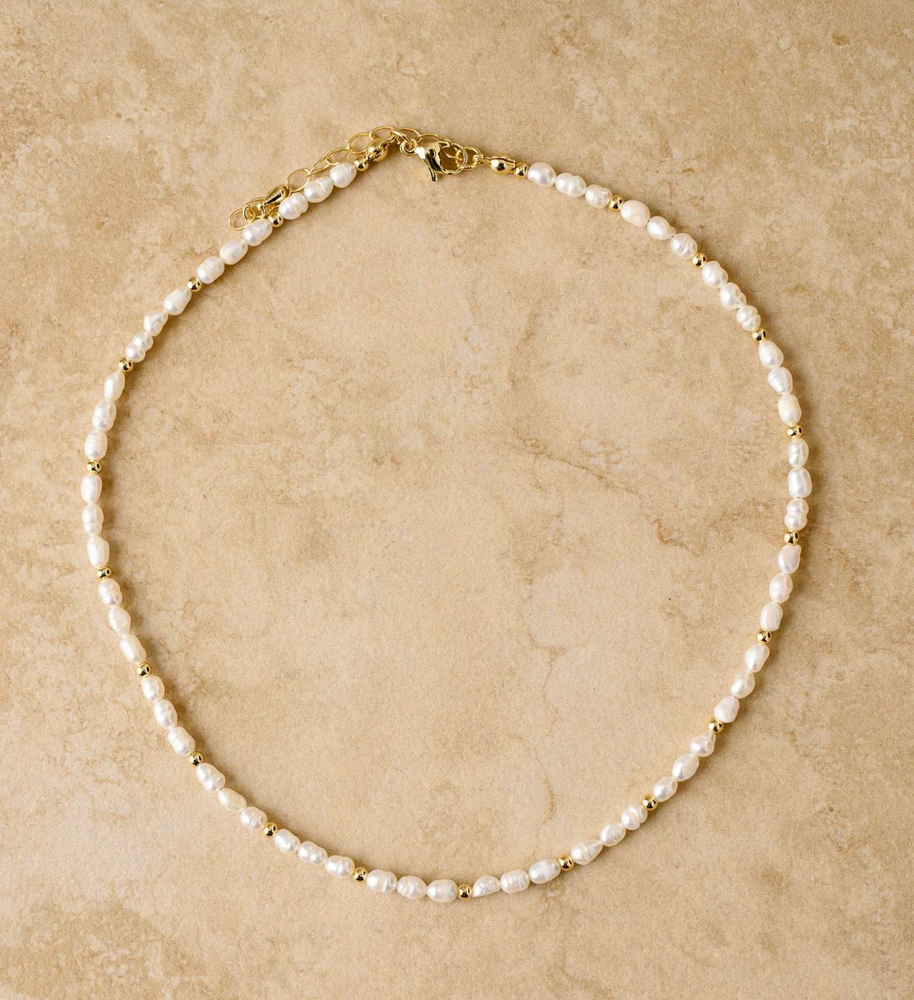 Be the epitome of elegance with LACEY, the fresh water pearl necklace that adds a touch of grace to any outfit. It's the perfect accessory for a classy night out.
S925 Gold Plated Sterling Silver
Freshwater Pearls/Crushed Gold Stones
Lead, Nickel & Tarnish Free
Hypoallergenic
Measures 38cm + 5cm in length