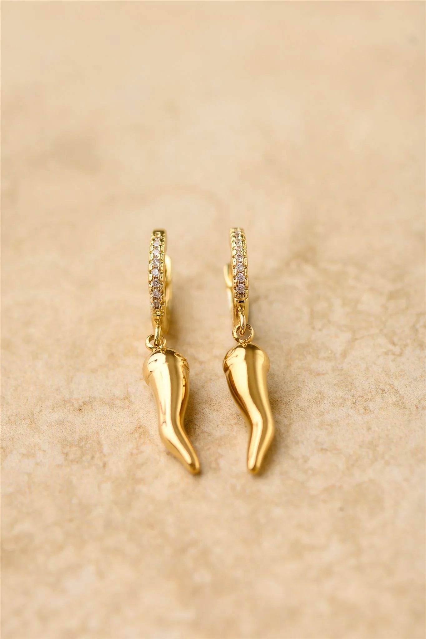 Add a little spice to your style with Oro! These charm earrings feature a golden chilli on a cubic zircon hoop, adding a playful twist to any outfit. Who says fashion can't be hot!
925 Gold Plated Sterling Silver
Cubic Zircon
Lead,Nickel & Tarnish Free
Hypoallergenic
Waterproof