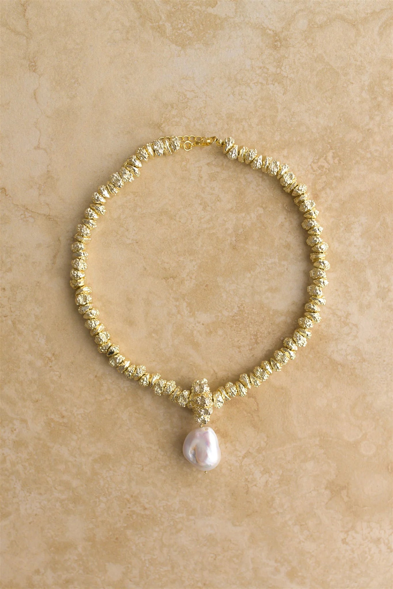 Indulge in luxury with JEWEL by Indigo and Wolfe, a 24Kt Gold Vermeil necklace featuring a stunning Baroque Pearl. This exclusive piece is a must have to elevate your outfit.
