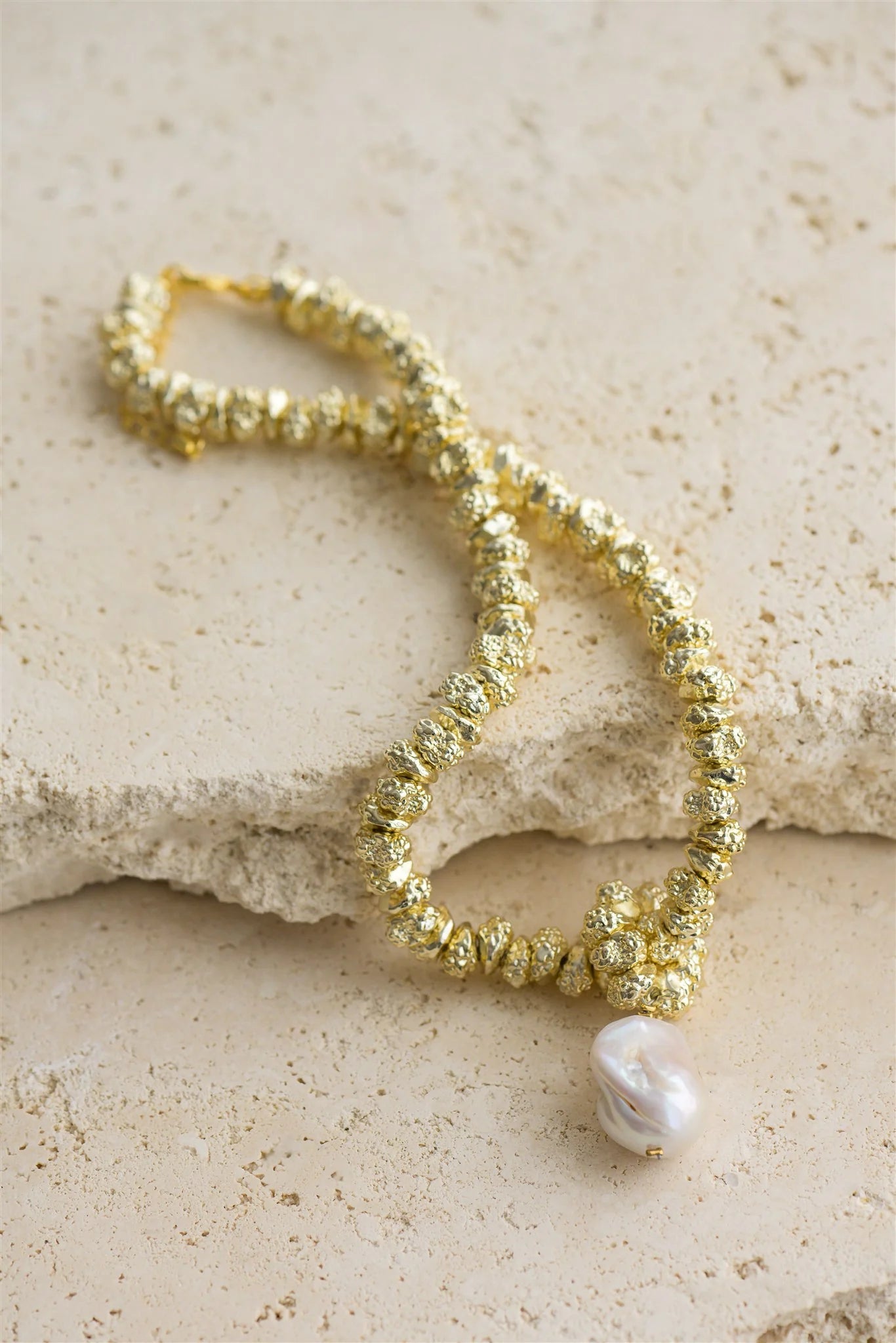 Indulge in luxury with JEWEL by Indigo and Wolfe, a 24Kt Gold Vermeil necklace featuring a stunning Baroque Pearl. This exclusive piece is a must have to elevate your outfit.