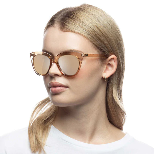 Lending a modern take to the classic cat-eye silhouette, our wardrobe staple HALFMOON MAGIC has been carefully designed to flatter all face shapes. With sweeping lines and midsize proportions, this style is finished with the iconic Le Specs flagstripe metal hardware on both temples. Finished in a rich translucent frame paired with tonal mirrored lenses.