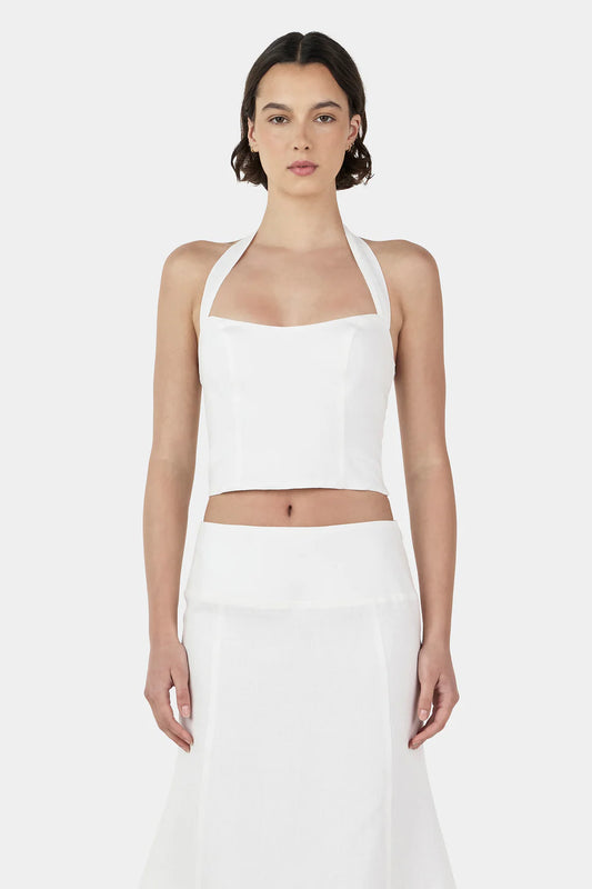 The Lee Lee Linen Top is a bodice corset top with princess seams for a flattering shape. There is a shirring panel at the back and wide straps that go into a halter neck. Pair with the matching Bambi Linen Skirt for a complete look.