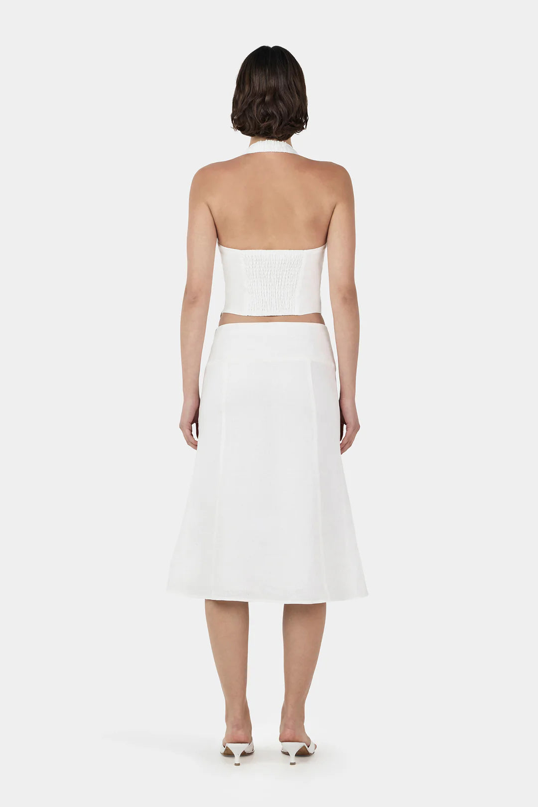 The Lee Lee Linen Top is a bodice corset top with princess seams for a flattering shape. There is a shirring panel at the back and wide straps that go into a halter neck. Pair with the matching Bambi Linen Skirt for a complete look.