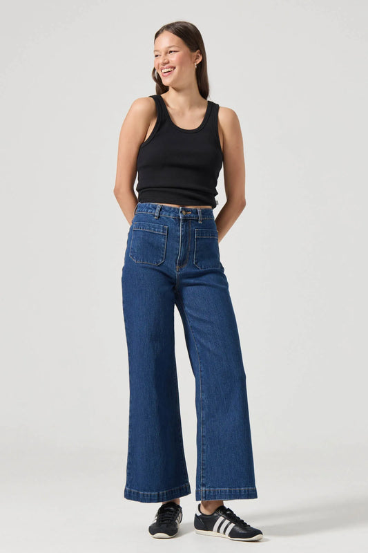 This is a super high-rise, wide leg jean, made with a comfort rigid denim. Fits true to size.
The Sailor Jean:
High rise, slim fit with a sailor wide leg
Fits smaller in the waist to eliminate gaps at the back waistband
Features Rolla's signature back pockets & sailor style patch front pockets
Specially angled and shaped in the back for a truly peachy looking butt
Comfort rigid denim which gives you the look of a vintage jean but the comfort of stretch
Zip closure
Made with vintage gold toned hardware