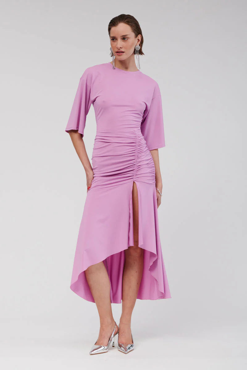 The Lucia Maxi is an exquisite cape-sleeve dress crafted from luxe, slinky jersey for an effortless drape. Designed with refined ruching at the hips and an elongated hem, it offers a hint of allure through a front split that enhances its modern appeal. This pull-on silhouette flows beautifully, highlighting feminine contours with grace.
