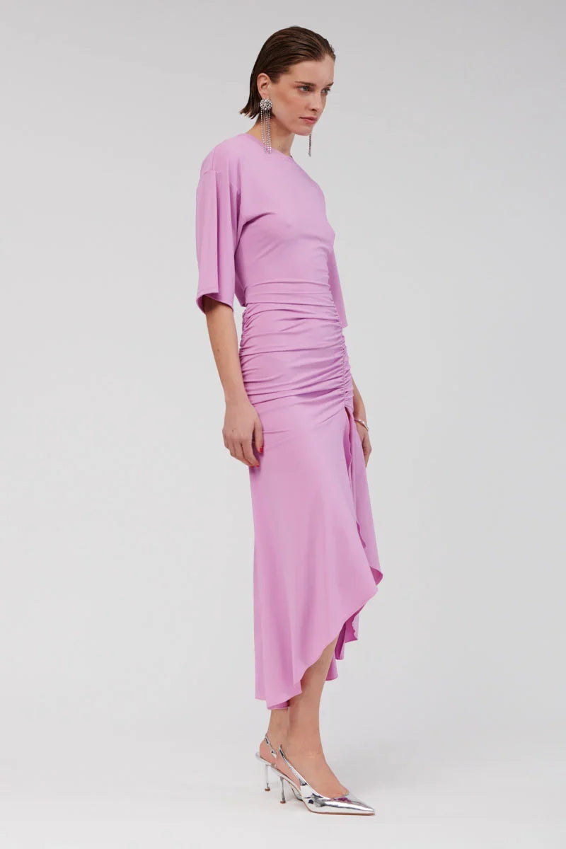 The Lucia Maxi is an exquisite cape-sleeve dress crafted from luxe, slinky jersey for an effortless drape. Designed with refined ruching at the hips and an elongated hem, it offers a hint of allure through a front split that enhances its modern appeal. This pull-on silhouette flows beautifully, highlighting feminine contours with grace.