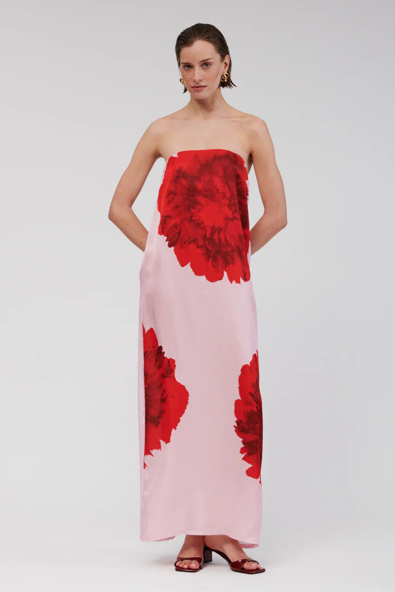 Step into relaxed sophistication with the Emilia Bustier Maxi Dress. Featuring a bold, enlarged red floral print on pink, this silky piece is perfect for a daytime event or a balmy summer soirée. Make a statement in this stunning max.