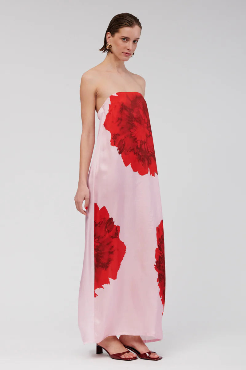 Step into relaxed sophistication with the Emilia Bustier Maxi Dress. Featuring a bold, enlarged red floral print on pink, this silky piece is perfect for a daytime event or a balmy summer soirée. Make a statement in this stunning max.