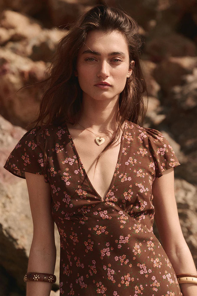 Our Melody Bias Maxi Dress in Antique Walnut is crafted for the heartbreakers. An exquisite showstopper, our dress is cut to flatter the waist and glide over the hips accentuating your silhouette. Soft pink ditsy florals ramble across a backdrop of deep chocolate brown, flutter sleeves float sweetly at the shoulder and the V neckline and low V back adds a sensual touch. Pair with mules and fine jewels for date night or with combat boots and a slouch bag for something a little more rock and roll.