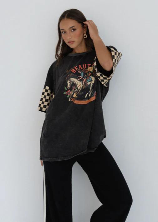 Black Beauty Tee
Make a bold statement with the Black Beauty Tee — featuring a vintage-inspired graphic print and edgy checkerboard sleeve details. This oversized, washed black tee blends comfort and street-style effortlessly, perfect for laid-back days or dressing up with your favorite accessories.