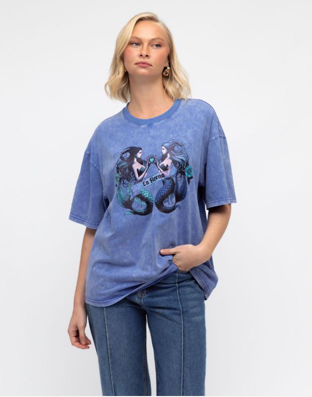 Dive into effortless style with the La Sirena Tee. Crafted in a washed blue cotton for a perfectly lived-in feel, this oversized tee features a bold twin mermaid graphic with “La Sirena” across the front. With its relaxed fit, drop shoulders, and vintage-inspired finish, it’s the ultimate statement piece for laid-back days and ocean dreamers.