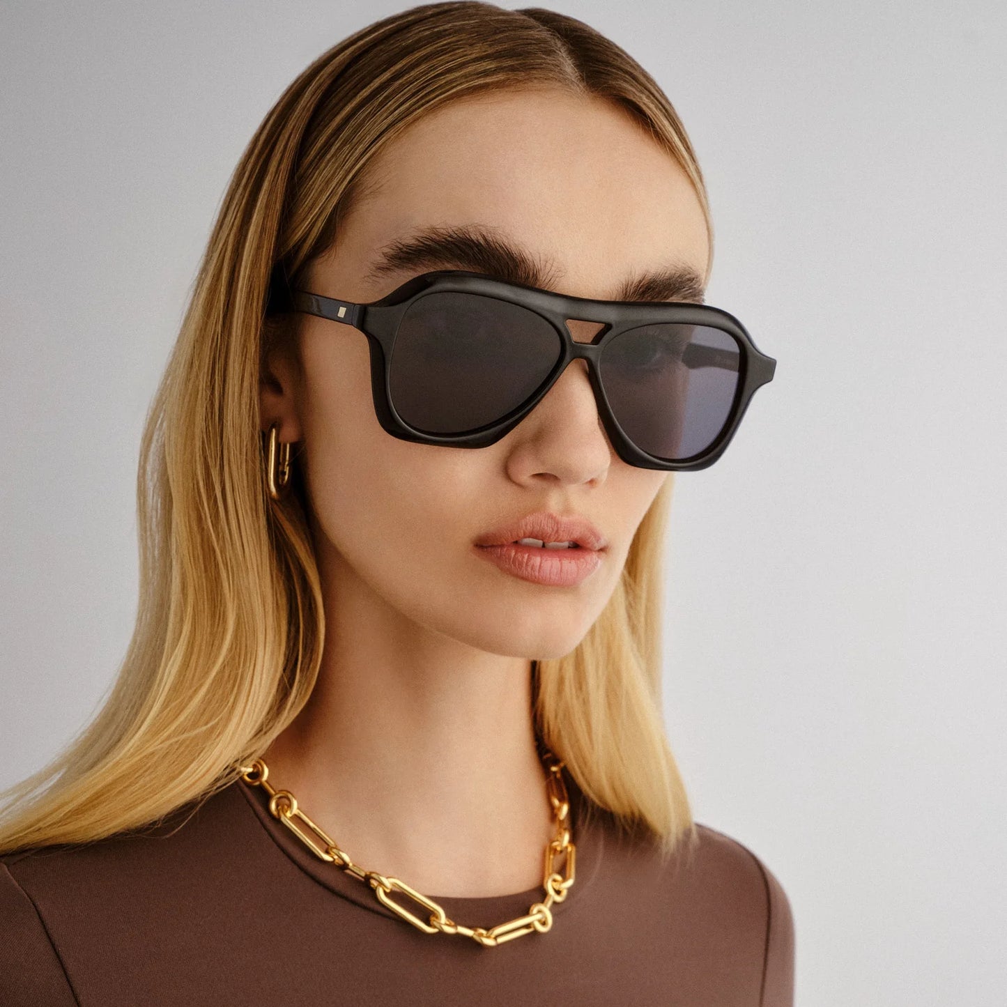 Inspired by millennial pop culture, our DRIZZLE sunglasses are the latest take on the classic aviator silhouette. Featuring a three-dimensional bevelled profile, this midsize frame offers flattering unisex proportions and is detailed with our understated pyramid stud hardware on both temples.
• Finished in classic black with dark lenses for an everyday look.
• Made using BPA free polymer plastic which is lightweight, durable and impact resistant.
• Fitted with shatterproof and scratch resistant polycarbona