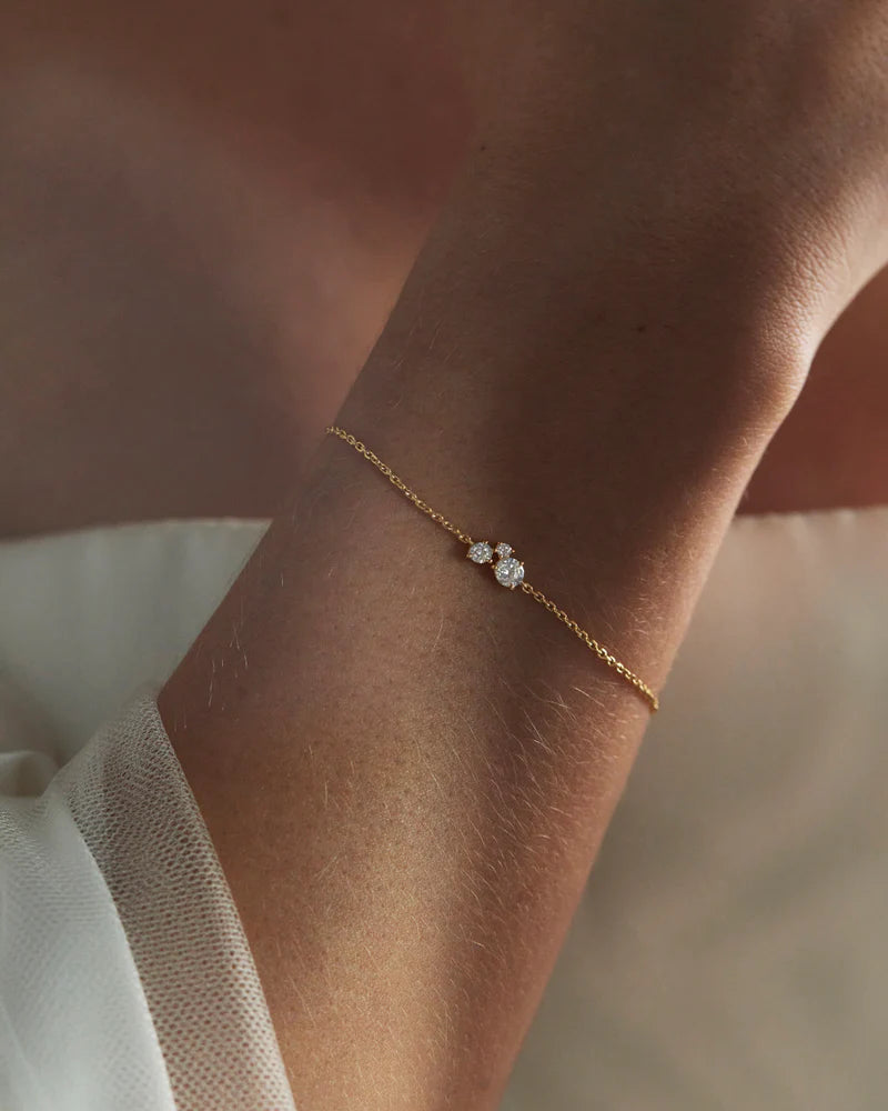 The Whispers of Love Bracelet features a classic trio design with an asymmetrical twist with varying sizes of round-cut crystals. This piece is a visual poem to the simplicity of love - and all the quiet magic it holds. It’s classic and delicate design is the perfect subtle touch of sparkle for the bride looking to shine in her own light.
Available in 18k gold vermeil and sterling silver.
2.5 microns of 18 carat gold coating a sterling silver base. 