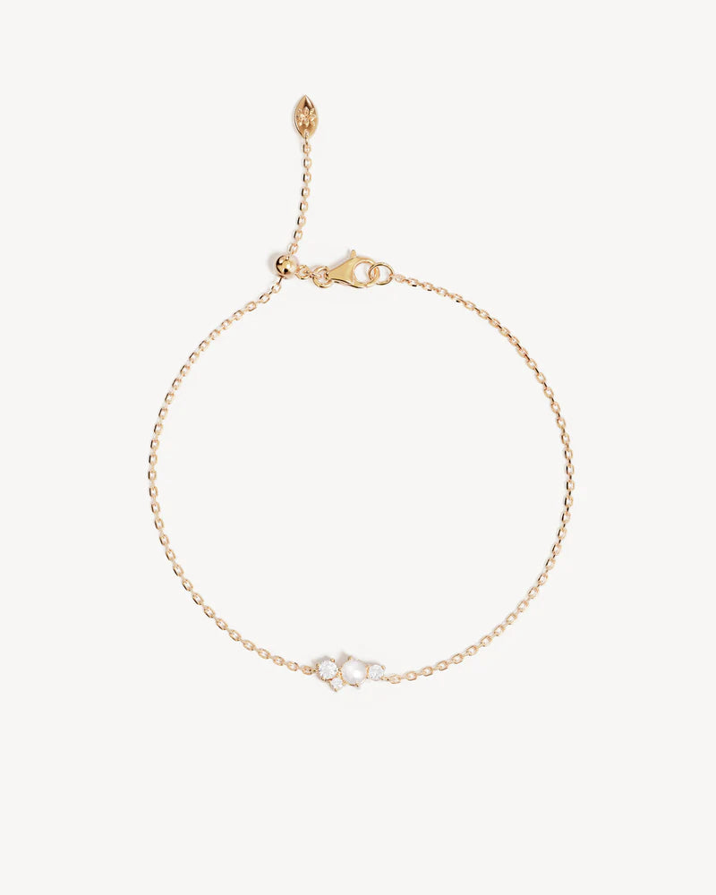 The Love in Stillness Pearl Bracelet celebrate those unseen moments - when we close our eyes to feel deeper, to connect beyond sight with love, with memory, with presence. This keepsake is an expression of romance in its softness and stillness.
18k Gold Vermeil: 2.5 microns of 18 carat gold coating a sterling silver base.
Delicate pearl cluster design.
Set with a round freshwater pearl and cubic zirconias in a claw setting.
Bracelet length: 19cm.
Features a silicon ball sl