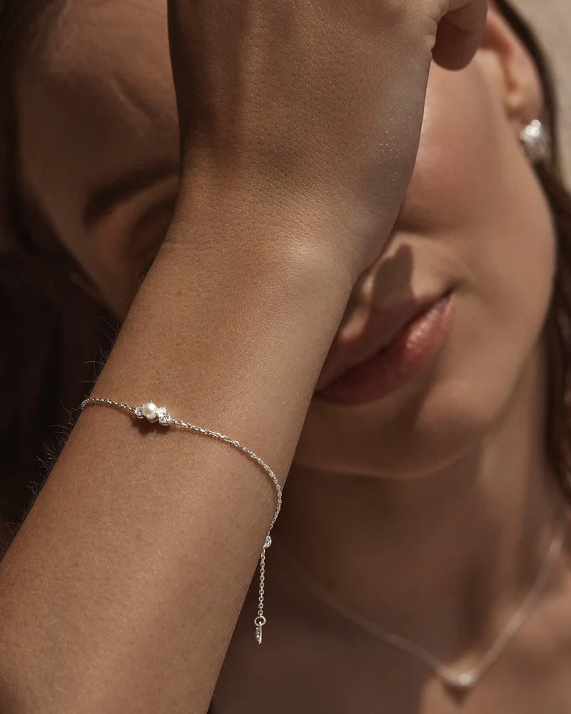The Love in Stillness Pearl Bracelet celebrate those unseen moments - when we close our eyes to feel deeper, to connect beyond sight with love, with memory, with presence. This keepsake is an expression of romance in its softness and stillness.
18k Gold Vermeil: 2.5 microns of 18 carat gold coating a sterling silver base.
Delicate pearl cluster design.
Set with a round freshwater pearl and cubic zirconias in a claw setting.
Bracelet length: 19cm.
Features a silicon ball sl