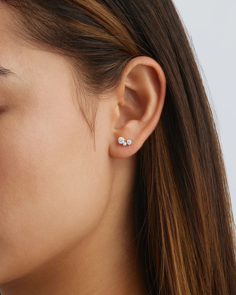 The Whispers of Love Stud Earrings feature a classic trio design with an asymmetrical twist with varying sizes of round-cut crystals. This piece is a visual poem to the simplicity of love - and all the quiet magic it holds. It’s classic and delicate design is the perfect subtle touch of sparkle for the bride looking to shine in her own light. 