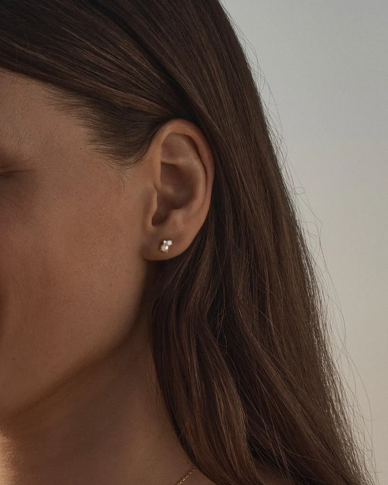 By Charlotte - The Love in Stillness Pearl Stud Earrings celebrate those unseen moments - when we close our eyes to feel deeper, to connect beyond sight with love, with memory, with presence. This keepsake is an expression of romance in its softness and stillness.
18k Gold Vermeil: 2.5 microns of 18 carat gold coating a sterling silver base.
Delicate pearl cluster design.
Set with a round freshwater pearl and cubic zirconias in a claw setting.
Sold as a pair.
6 x 4mm. 