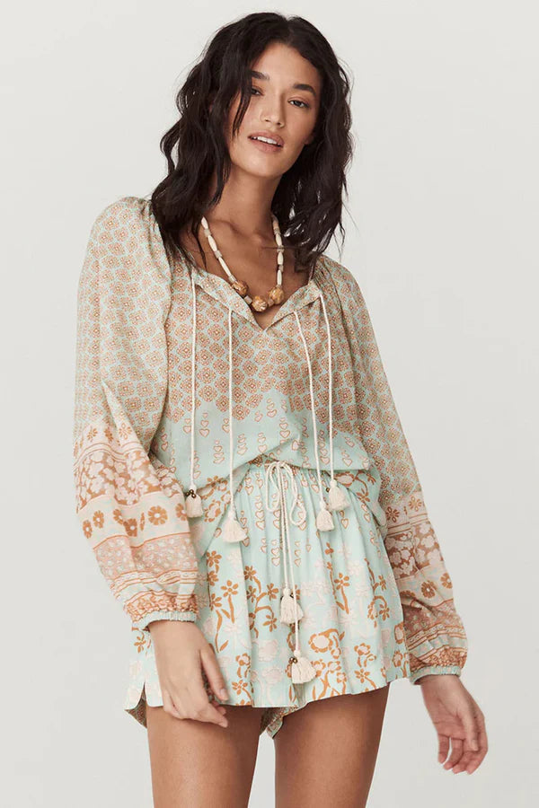 Our Sweet Nothings Blouse in Peppermint evokes the beauty of an ocean breeze. Four tassel-trimmed ties with bells adorn the neckline, allowing you to wear it open or tied for a look that’s both sweet and sophisticated