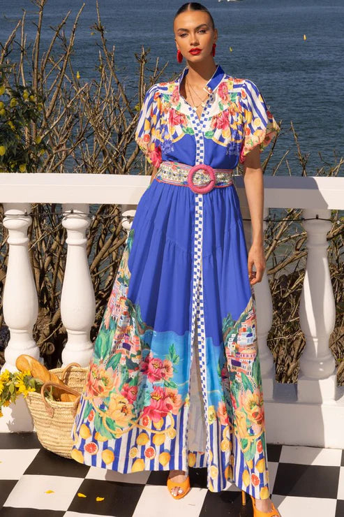 Bright, bold, and full of summer charm — the Positano Maxi Dress in Cobalt Blue is designed to turn heads. Crafted from a lightweight linen-blend fabric, this dress features a flattering gathered waist with a hidden elastic and a wide statement belt with a lemon-rattan buckle. The mandarin collar and stripe-contrast hemline add a playful touch, while the balloon sleeves and cotton lining ensure comfort and breathability. Perfect for Event / Race Wear, or Long Lunches.