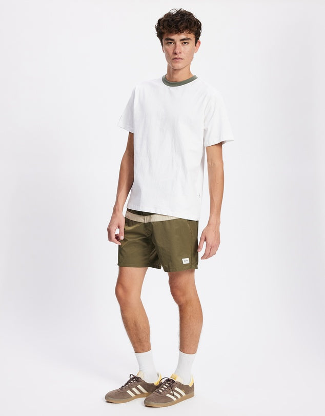 Inspired by vintage surf culture and built for modern adventure, the Market Trunks deliver effortless coastal style with everyday versatility. Crafted from recycled nylon for a lightweight yet durable feel, these trunks are designed to move with you — from the ocean to the street.
Featuring a contrast stripe design and a classic fixed waistband with a secure drawcord closure, they offer a timeless look with a tailored fit. Quick-drying and functional, they’re perfect for surf sessions, beach hangs, or week