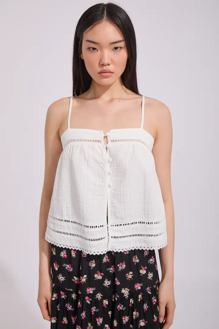 The Macy Scallop Top is the ultimate blend of effortless femininity and coastal charm. Crafted from lightweight cotton with a softly textured finish, this breezy top features delicate scalloped hems and intricate ladder lace detailing that elevate its simple silhouette.