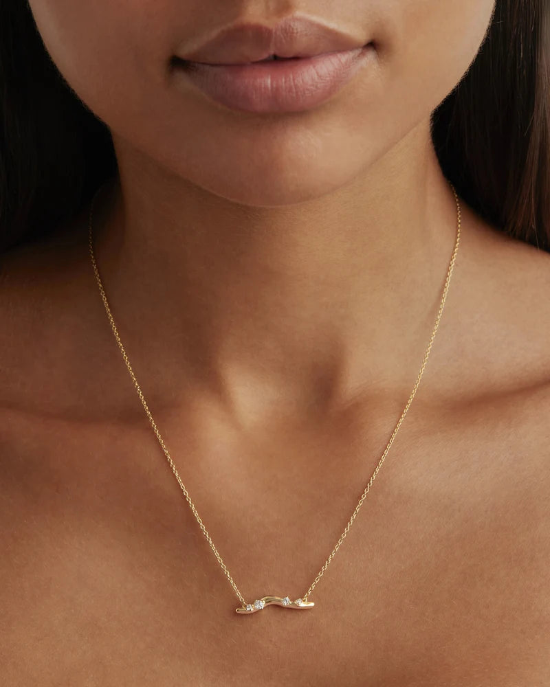 Our 18k Gold Vermeil Chasing Tides Necklace is inspired by the uninhibited soul-freeing euphoria of chasing tides and dancing with the waves. Featuring undulating and organic shapes inspired by ocean waves, this keepsake is perfect for everyday wear and layering. 