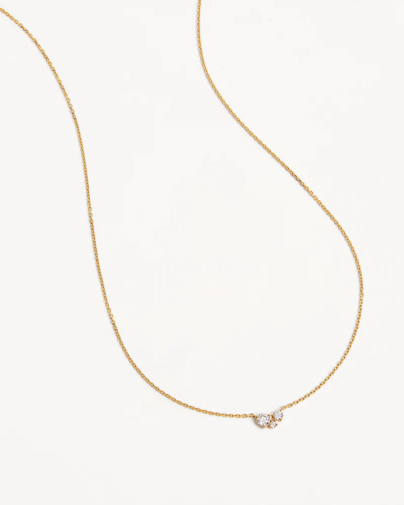 The Whispers of Love Necklace features a classic trio design with an asymmetrical twist with varying sizes of round-cut crystals. This piece is a visual poem to the simplicity of love - and all the quiet magic it holds. It’s classic and delicate design is the perfect subtle touch of sparkle for the bride looking to shine in her own light. 