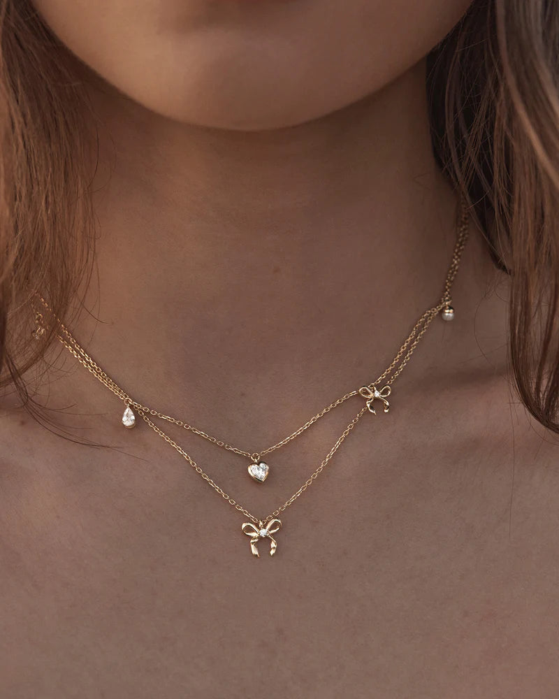 The Forever Yours Charm Choker is a reminder to embrace love in all its forms; its depth, stillness and radiance. This playful, feminine and delicate charm design is perfect for layering back with your favourite By Charlotte styles.
18k Gold Vermeil: 2.5 microns of 18 carat gold coating a sterling silver base.
Necklace length: 16 inches (40.64cm).
Features a silicon ball slider to customise length.