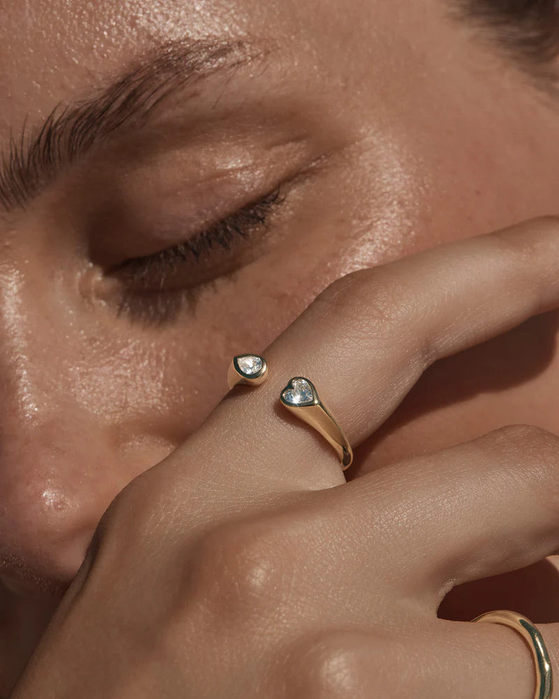 By Charlotte - The With Every Breath Ring is an ode to love and connection - when hearts and souls collide. Set with pear and heart cut cubic zirconias, this keepsake speaks to the unspoken connections that we hold closest to our hearts.
18k Gold Vermeil: 2.5 microns of 18 carat gold coating a sterling silver base.
Open band ring.
Set with pear and heart cut crystals.
Band height: 2 - 5mm (tapers).
Set with pear and heart cut cubic zirconias.
Polished finish.