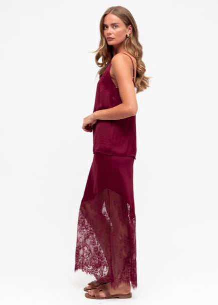 Unleash your bold side with our fierce Liberty Lace Trim Cami in Wine! This stunning top features a silky soft fabric, delicate lace trim, and adjustable straps. It's fully lined for ultimate comfort and style. Lace up your look today!