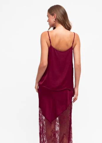 Unleash your bold side with our fierce Liberty Lace Trim Cami in Wine! This stunning top features a silky soft fabric, delicate lace trim, and adjustable straps. It's fully lined for ultimate comfort and style. Lace up your look today!