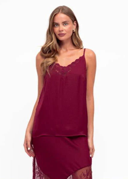 Unleash your bold side with our fierce Liberty Lace Trim Cami in Wine! This stunning top features a silky soft fabric, delicate lace trim, and adjustable straps. It's fully lined for ultimate comfort and style. Lace up your look today!
