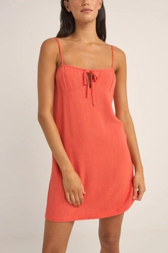 Indulge in effortless coastal style with Seacoast Keyhole Slip Dress. This coastal gem features a scoop neckline, a front keyhole with a tie, and an under bust panel for a flattering fit. The fitted bodice effortlessly flows into a slightly fitted skirt, while binding on the front and back openings adds a touch of elegance. Adjustable spaghetti straps ensure a personalized fit, and resin bead detailing at the centre front tie completes the look with coastal charm.