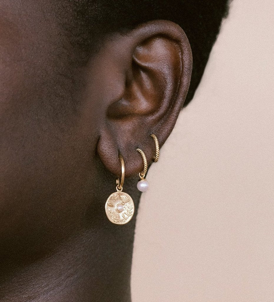 Impassioned by the ocean, and observing the delicacy of its intrinsic treasure, these By The Sea Hoops pay homage to the subtle and sculptural detail the waves deliver at the turning of each tide