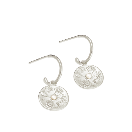 Impassioned by the ocean, and observing the delicacy of its intrinsic treasure, these By The Sea Hoops pay homage to the subtle and sculptural detail the waves deliver at the turning of each tide.