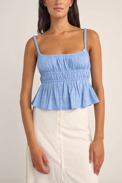 The Cornflower Tyler Baby Doll Top breezes into your wardrobe with a nod to carefree days by the sea. Its 100% cotton and textured checked fabric weave comfort and style into a baby doll silhouette that flutters with every coastal breeze. Featuring elasticated straps and under bust for a playful, gathered look, it's a sunlit melody of fabric and ocean air.
