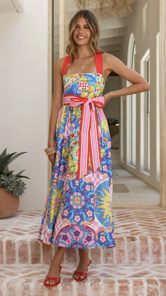 The Polly Maxi Dress in Summer In Sicily is an elegant statement piece with timeless appeal. This maxi features a striking halter neckline with substantial straps that provide support and visual interest, while the fitted bodice is beautifully defined by a contrast waistband. The flowing A-line skirt creates a graceful silhouette, and a back centre zipper ensures a seamless, polished finish.&nbsp;